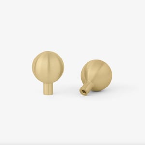 May include: Two brushed gold round cabinet knobs with a small stem.