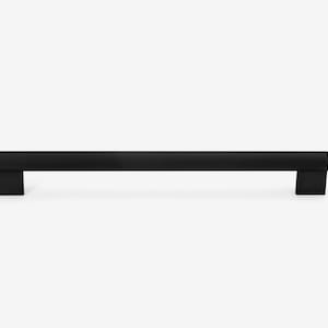 May include: Black metal cabinet pull with rounded ends and square bases.