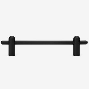 May include: A matte black cabinet pull with a horizontal bar and rounded ends. The pull has two vertical posts with rounded tops and horizontal extensions. This modern hardware is designed for cabinets and drawers.