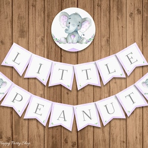 May include: Purple and white banner with the text "Little Peanut" in gray letters. The banner is decorated with small green leaves and gray elephants. A separate circle sticker features a gray elephant with purple polka dots.