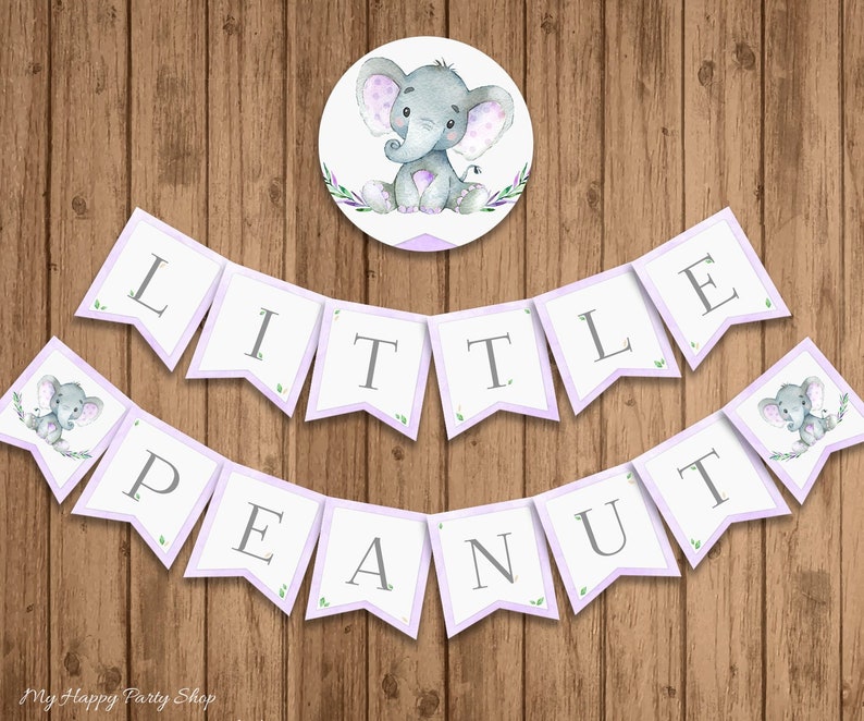 May include: Purple and white banner with the text "Little Peanut" in gray letters. The banner is decorated with small green leaves and gray elephants. A separate circle sticker features a gray elephant with purple polka dots.