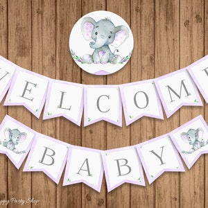 May include: Purple and white welcome baby banner with a gray elephant illustration. The banner says "Welcome Baby" with a small elephant illustration on each end.