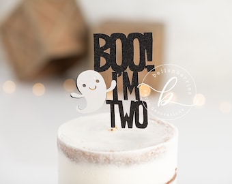 May include: Black and white cake topper with a ghost and the text "Boo I'm Two".