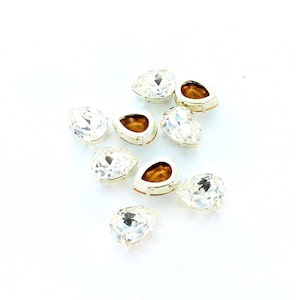 Swarovski 4320 8x6, 14x10, 15x11mm  pear shaped stone in sew on setting.  Price is for 5 or 10 stones