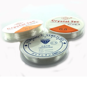 May include: Three spools of clear elastic string, labeled "Crystal Tec Korea" with different sizes: 0.4, 0.6, and 0.8. The label also says "Strong & Stretchy" and "Crystaline 100% Polyurethane".