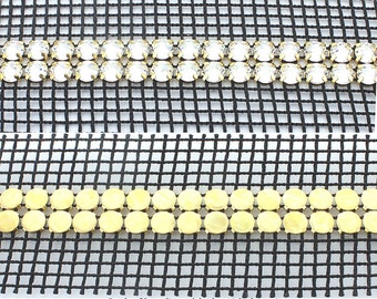 Rhinestone banding 2 row flatback SS20 (4.6mm) stones in gold settings with double sided netting. Price is for 1 and 0.5 meter