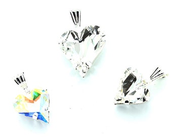 May include: Three silver heart-shaped pendants with clear crystal stones. The pendant on the left has a rainbow effect, while the other two pendants are clear.