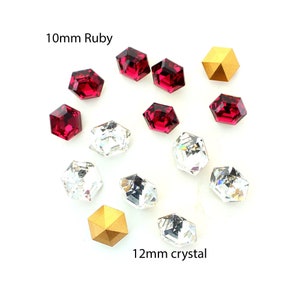 May include: Assortment of red ruby and clear crystal faceted rhinestones, with two gold-toned metal pyramid-shaped embellishments.  The ruby rhinestones are 10mm and the crystal rhinestones are 12mm.