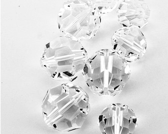 May include: A group of eight clear glass faceted round beads. The beads are approximately 1 inch in diameter and have a smooth, polished finish.