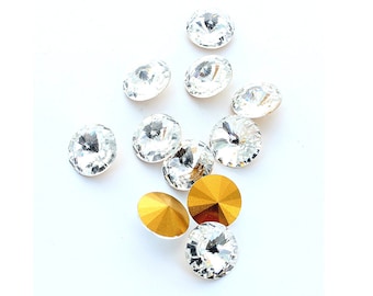 Rivoli 14mm crystal stones made by Preciosa.  The stones are pointed front and back and gold foiled,  Price is for 2 stones.