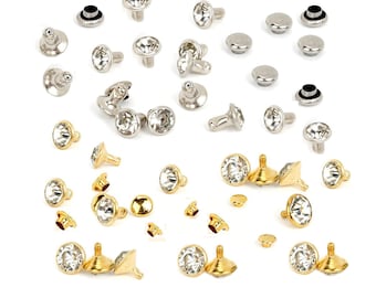 May include: Assortment of silver and gold-toned metal studs with clear rhinestone accents. The studs are in various shapes and sizes.