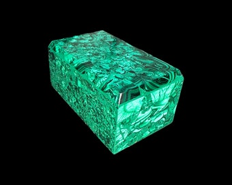 May include: A green malachite box with intricate patterns. The box is made of polished stone and has a rectangular shape.