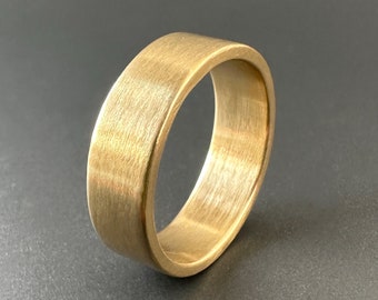 Gold wedding ring for man. Sterling silver wedding band for woman. Ethical sustainable bespoke luxury wedding jewellery. 6mm wide gold ring