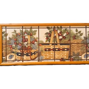 May include: A rectangular wooden framed decorative panel featuring a series of images of baskets filled with berries and flowers. The panel is divided into sections with a grid pattern, and the artwork has a rustic, country style.