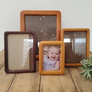 May include: A set of three ceramic mugs with a speckled, matte finish. The mugs are in shades of cream, light gray, and dark gray. Each mug has a simple, minimalist design, perfect for coffee or tea.