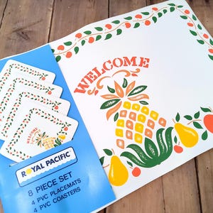 May include: A vintage 8-piece placemat and coaster set. The set includes four PVC placemats and four PVC coasters. The placemats and coasters are white with a fruit and leaf design and the word "WELCOME". The set is in a blue package.