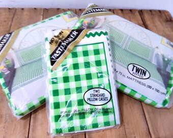 May include: Three packages of twin-size bed linens. The packages include a fitted sheet and two standard pillowcases. The pillowcases have a green and white gingham pattern. The fitted sheet is designed to fit a 39 x 75 inch mattress.