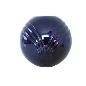 May include: A dark blue, spherical vase with a glossy finish. The vase features a stylized, symmetrical design of vertical lines radiating from the base, creating a textured surface. The opening is at the top.