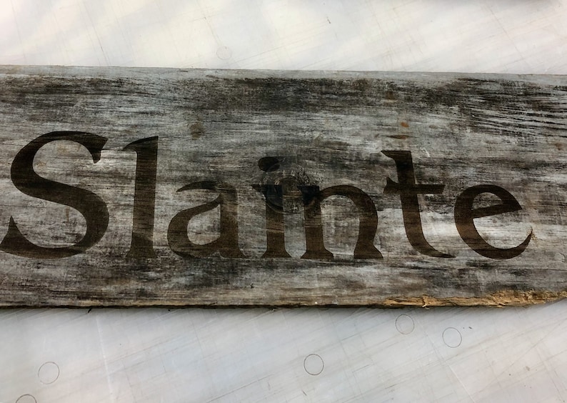 Slainte laser etched sign on weathered board