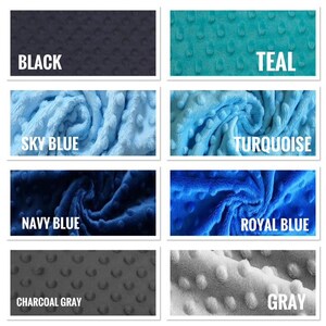 May include: A collection of plush fabric swatches in various colors, including black, teal, sky blue, turquoise, navy blue, royal blue, charcoal gray, and gray. Each swatch has a textured, dotted pattern and a white label with the color name.
