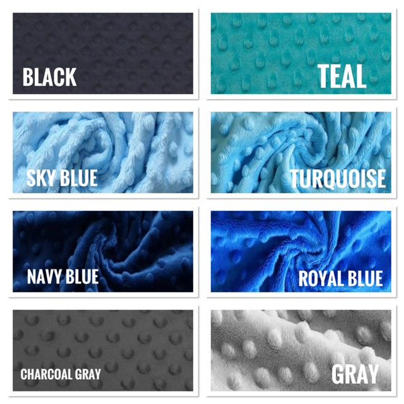 May include: A collection of plush fabric swatches in various colors, including black, teal, sky blue, turquoise, navy blue, royal blue, charcoal gray, and gray. Each swatch has a textured, dotted pattern and a white label with the color name.