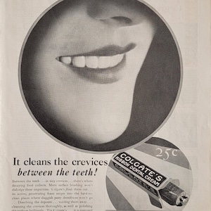 May include: Vintage black and white advertisement from the Ladies' Home Journal, May 1930, featuring a smiling face and a tube of Colgate's Ribbon Dental Cream. The ad text highlights the toothpaste's cleaning abilities.