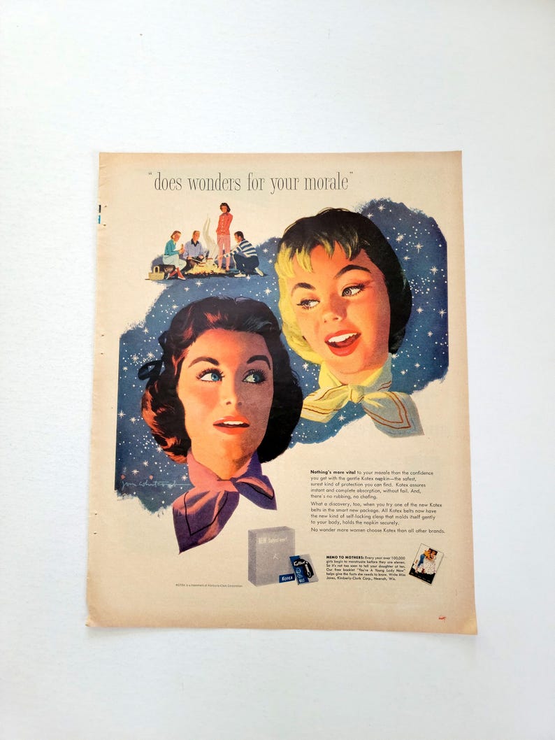 May include: Vintage advertisement featuring two women with stylized hair and scarves, set against a starry background. The text "does wonders for your morale" is at the top. A small box of product is also visible.