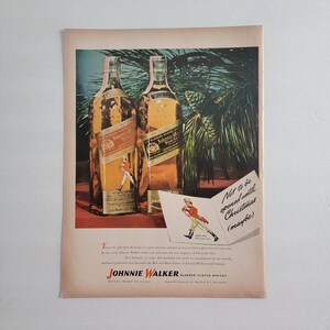 May include: Vintage advertisement featuring two bottles of Johnnie Walker Blended Scotch Whisky. The bottles have red and black labels. A small illustration of a man in a red coat is on the labels. Text reads "Not to be opened until Christmas (maybe)".