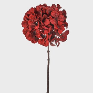 May include: A single, artificial hydrangea flower with deep red petals and a textured, glittery finish. The flower head is large and round, atop a long, brown stem. The background is plain white.