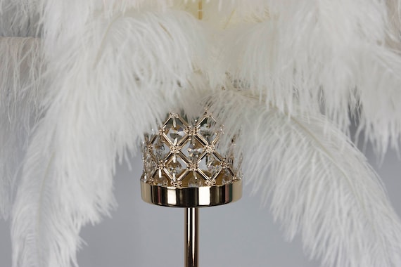 Great Gatsby style gold stands with palm leaves, feathers and pearls