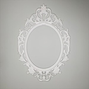 May include: White ornate oval picture frame with a decorative, intricate design. The frame is made of a smooth, white material and has a classic, elegant style.
