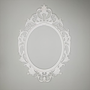 May include: White ornate oval picture frame with a decorative, intricate design. The frame is made of a smooth, white material and has a classic, elegant style.