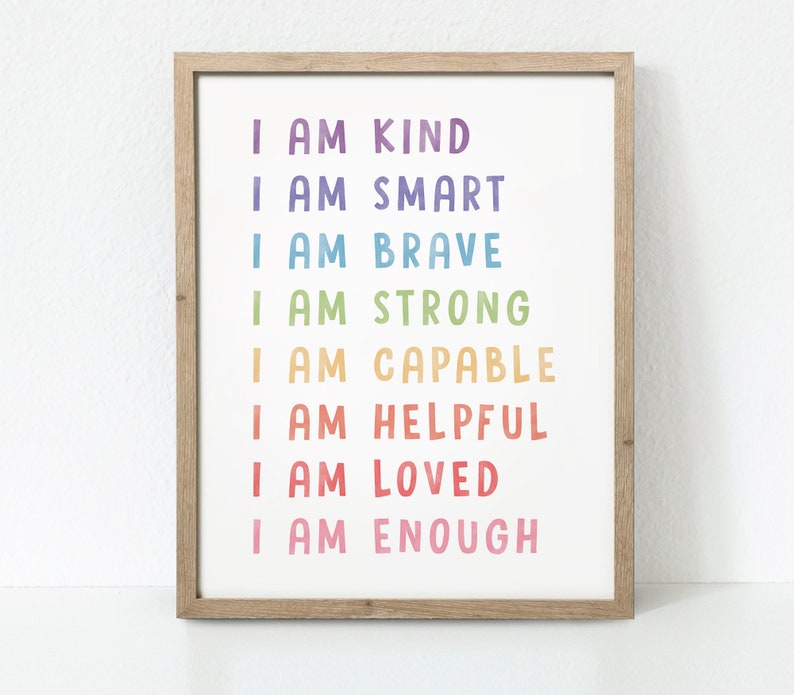 May include: A framed print with a rainbow gradient of text that reads "I am kind, I am smart, I am brave, I am strong, I am capable, I am helpful, I am loved, I am enough".