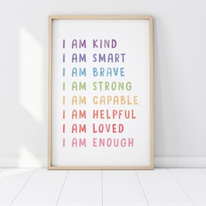 May include: A framed print with the text "I am kind, I am smart, I am brave, I am strong, I am capable, I am helpful, I am loved, I am enough" in a rainbow color scheme.