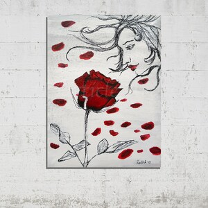 May include: A painting of a woman with flowing hair, her face turned towards a single red rose with petals falling around her. The background is a silver-grey color.