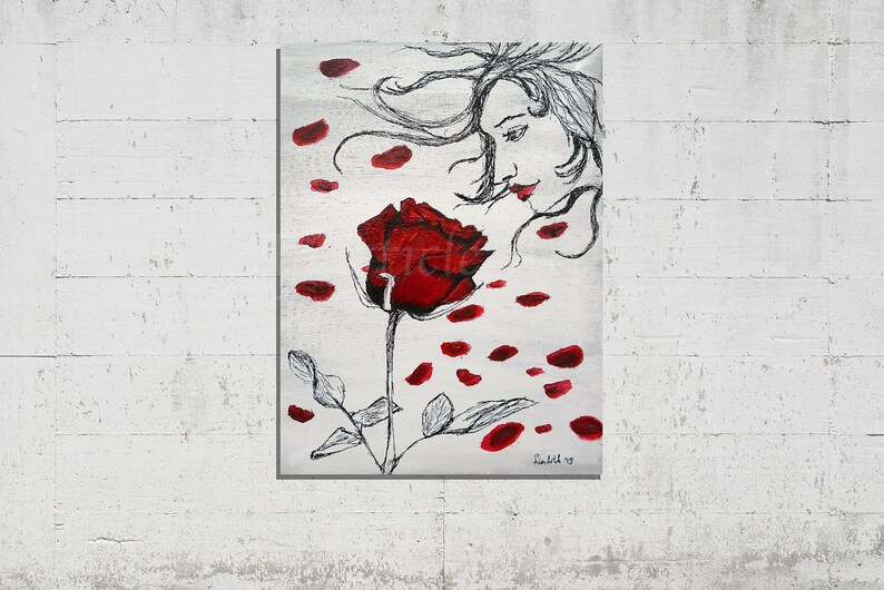 May include: A painting of a woman with flowing hair, her face turned towards a single red rose with petals falling around her. The background is a silver-grey color.