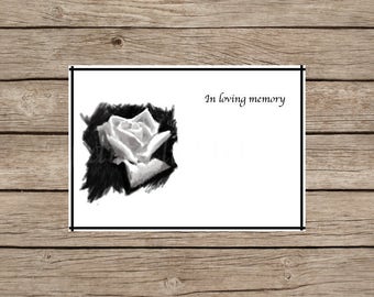 May include: A black and white image of a single white rose with the text "In loving memory" above it.