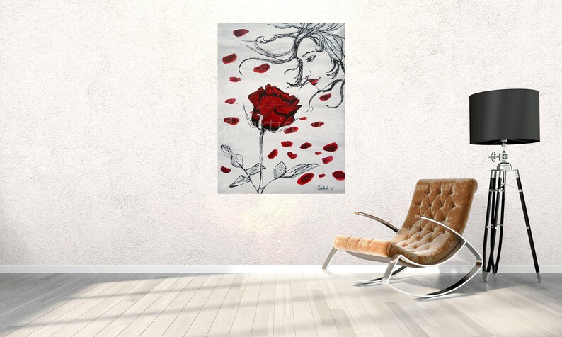 May include: A black and white painting of a woman with flowing hair, looking at a red rose with petals falling around it.