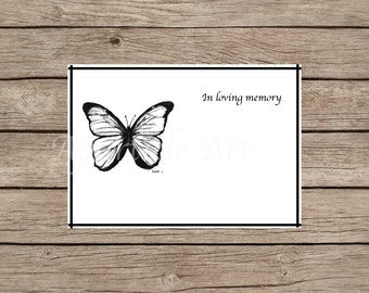 May include: A black and white drawing of a butterfly on a white card with the text "In loving memory" printed in black.