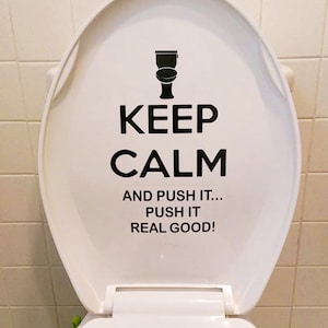 May include: White toilet seat with a black decal that says "Keep Calm and Push It... Push It Real Good!"