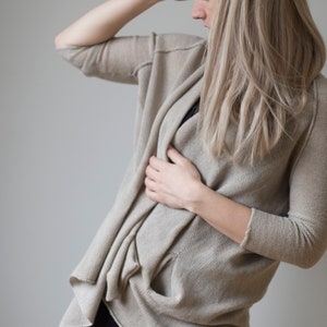 Open poncho cape with sleeves and pockets made of fine beige colored wool women&#39;s coat women&#39;s poncho wool sweater beige coat