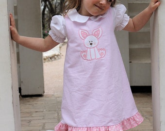 We're hopping into spring with this adorable Easter a-line dress.  Made of 100 percent pink/white cotton seersucker with a bunny applique.