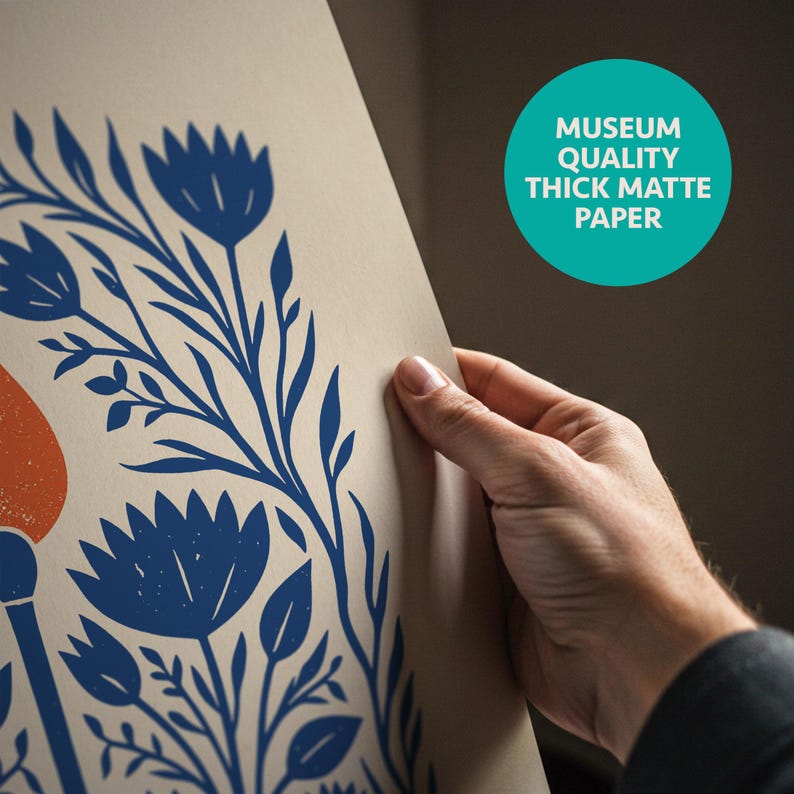 May include: A piece of thick matte paper featuring a blue floral print with stylized flowers and leaves on a light beige background. A teal circular badge in the upper right corner contains the text MUSEUM QUALITY THICK MATTE PAPER.