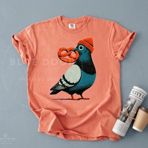 City bird shirt in terracotta styled with a rolled newspaper and black coffee, New York pigeon block print