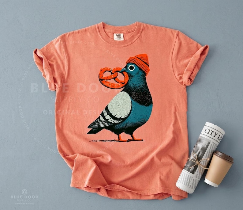 City bird shirt in terracotta styled with a rolled newspaper and black coffee, New York pigeon block print