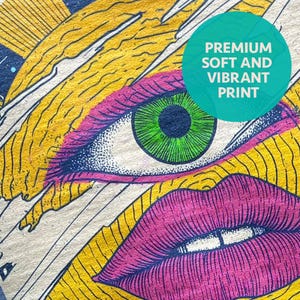 May include: A textile print featuring a stylized eye with a bright green iris and dark lashes, positioned above a pair of vibrant pink lips. The background consists of yellow and black wavy lines. A teal circle contains the text PREMIUM SOFT AND VIBRANT PRINT.