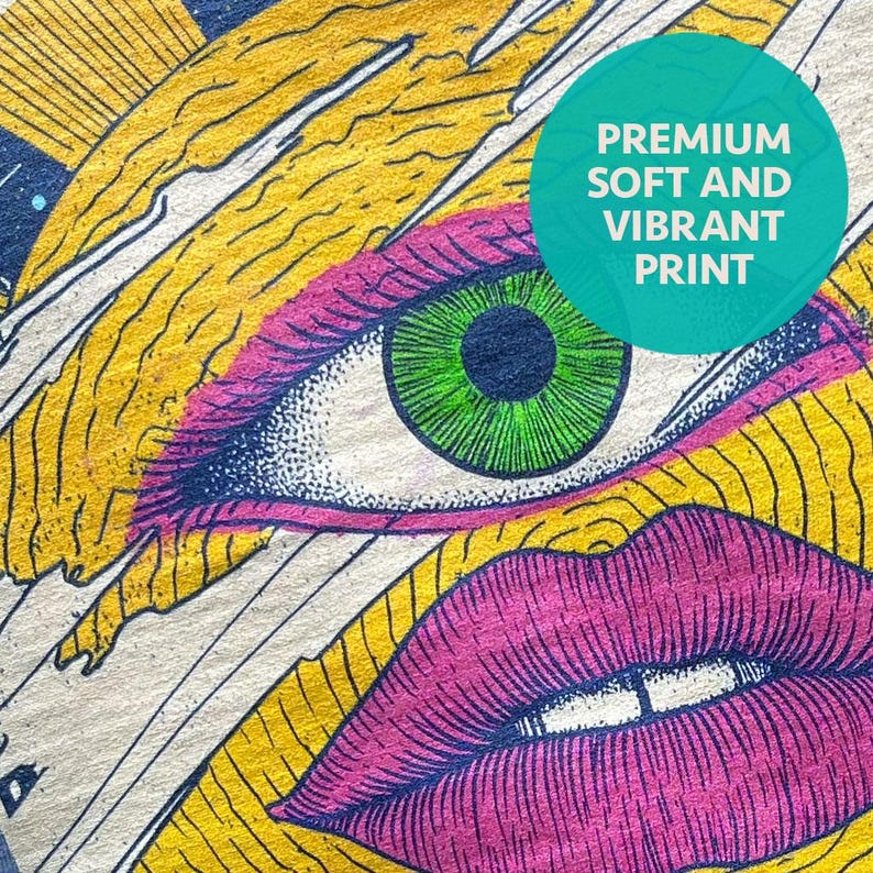 May include: A textile print featuring a stylized eye with a bright green iris and dark lashes, positioned above a pair of vibrant pink lips. The background consists of yellow and black wavy lines. A teal circle contains the text PREMIUM SOFT AND VIBRANT PRINT.