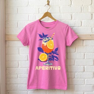 Aperitivo women's fitted graphic tee in pink on hanger — Italian summer spritz cocktail design, semi-fitted silhouette, available in pink, green, and red