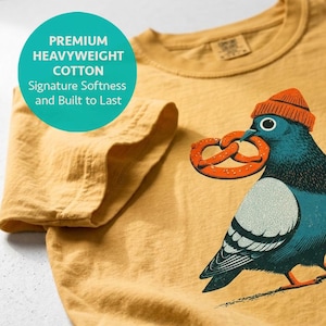 Bird nerd shirt in mustard, folded to show the heavyweight cotton and neckline, block print pigeon design
