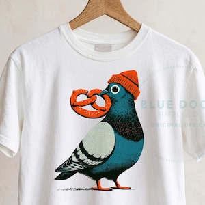 New York crop top in white on a wood hanger, city pigeon block print with correct blue-gray coloring